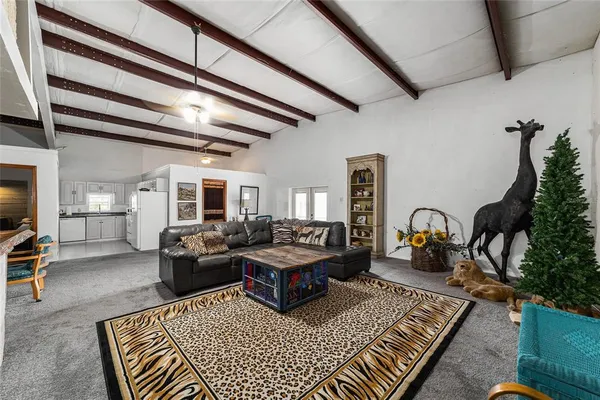 a room with table chairs and a refrigerator