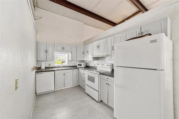 a view of a storage & utility room with two washing machine