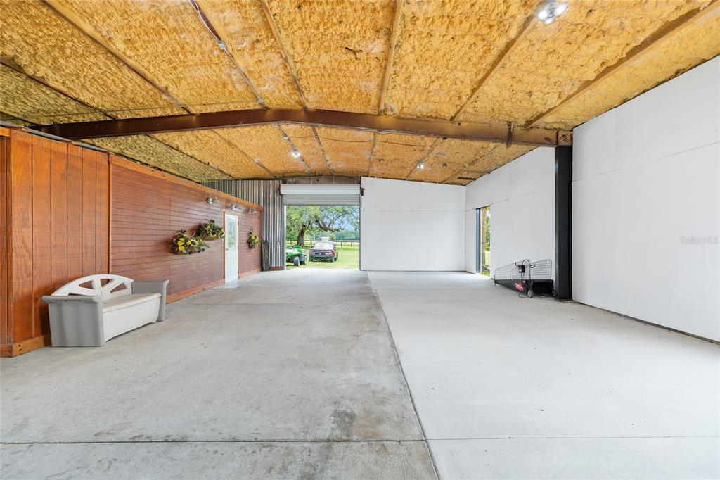 4520 Northwest 95th Avenue Road Ocala, FL 34482 - Photo 63 of 87 a view of a backyard with furniture and a garage