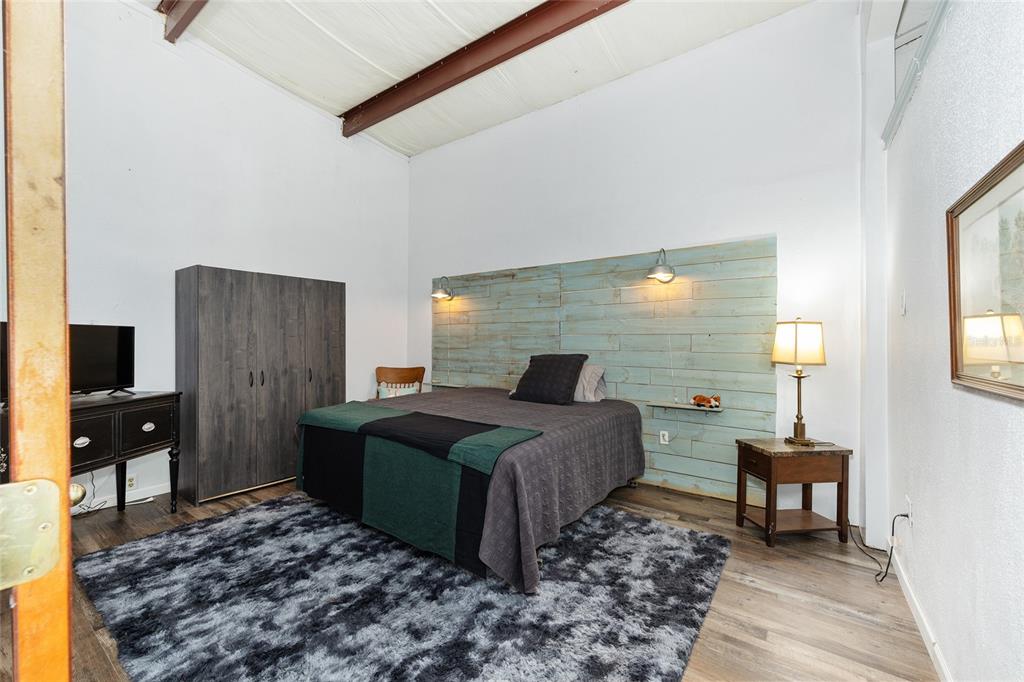 4520 Northwest 95th Avenue Road Ocala, FL 34482 - Photo 79 of 87 a bedroom with a bed and wooden floor