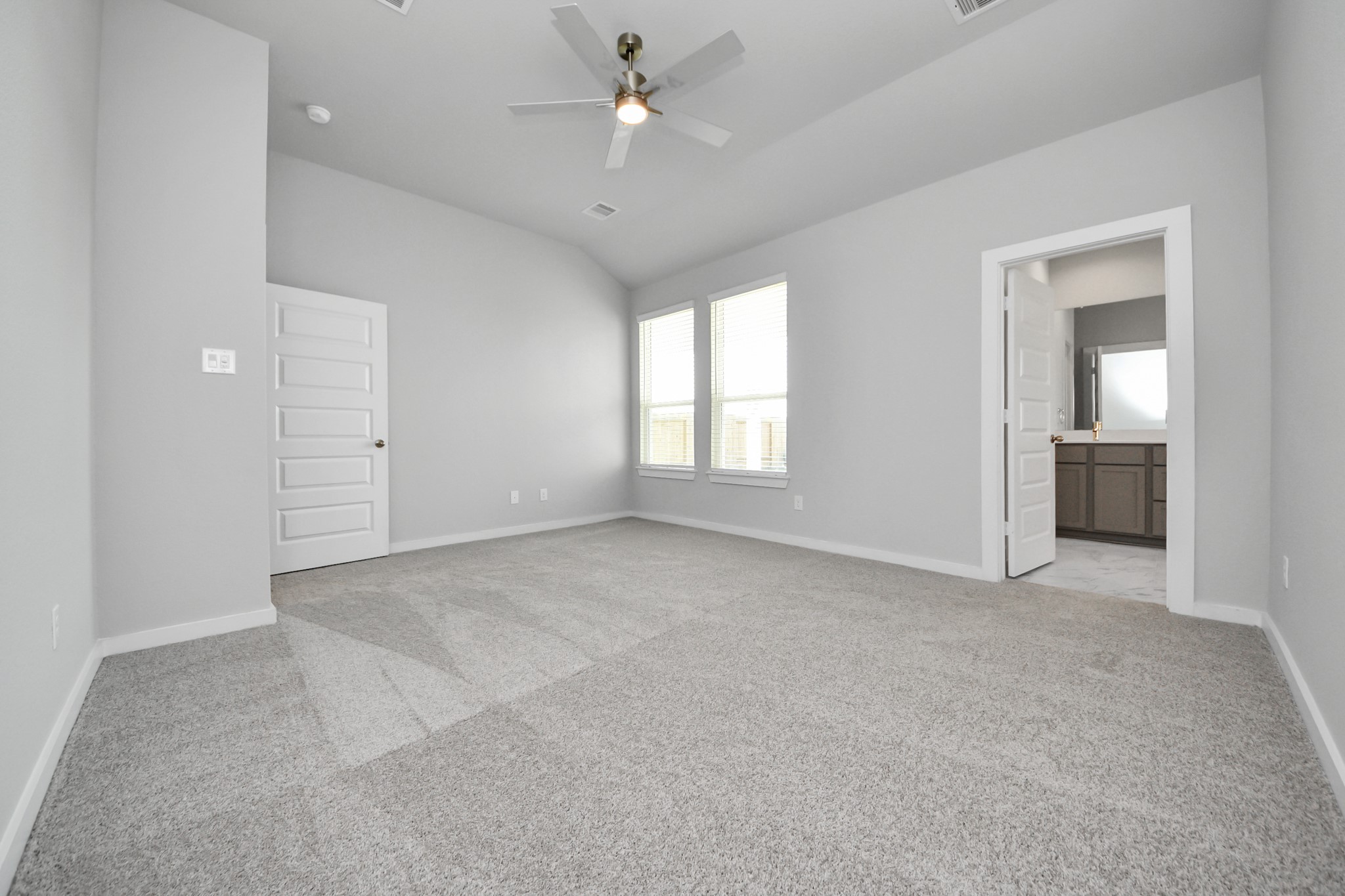 3002 Bury Park Dr Spring Spring, TX 77373 - Photo 25 of 45 Escape to tranquility in this spacious primary room, adorned with plush carpeting and bathed in the soothing hues of warm paint colors, creating a cozy retreat for relaxation.