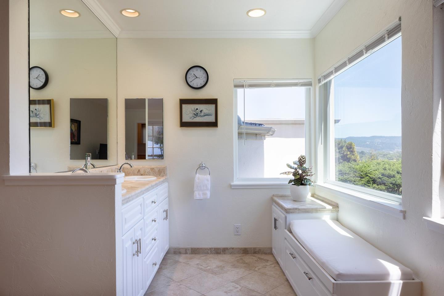 2920 Ribera Road Carmel, CA 93923 - Photo 12 of 18 a bathroom with a granite countertop sink mirror vanity and a large window