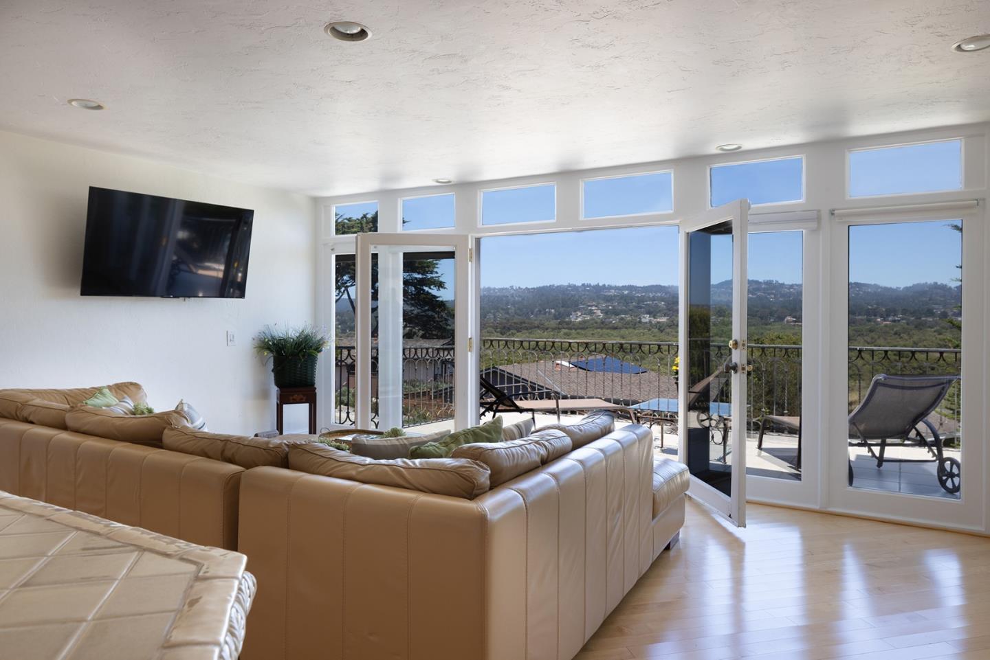 2920 Ribera Road Carmel, CA 93923 - Photo 9 of 18 a living room with furniture large windows and a flat screen tv