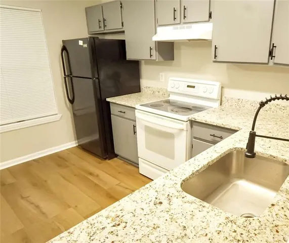 a kitchen with a refrigerator sink and stove