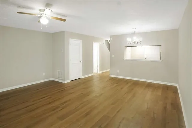 wooden floor in an empty room with a window