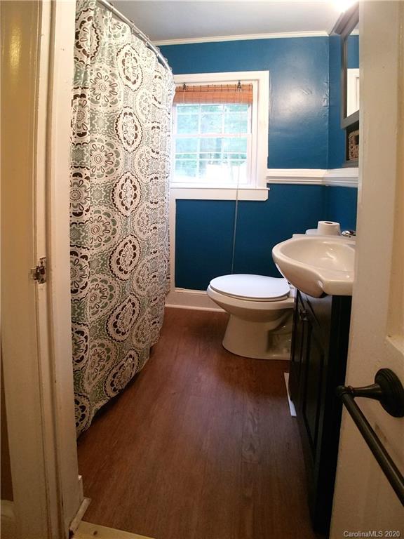 1900 Arnold Drive Charlotte, NC 28205 - Photo 11 of 23 a white toilet sitting next to a bathroom sink