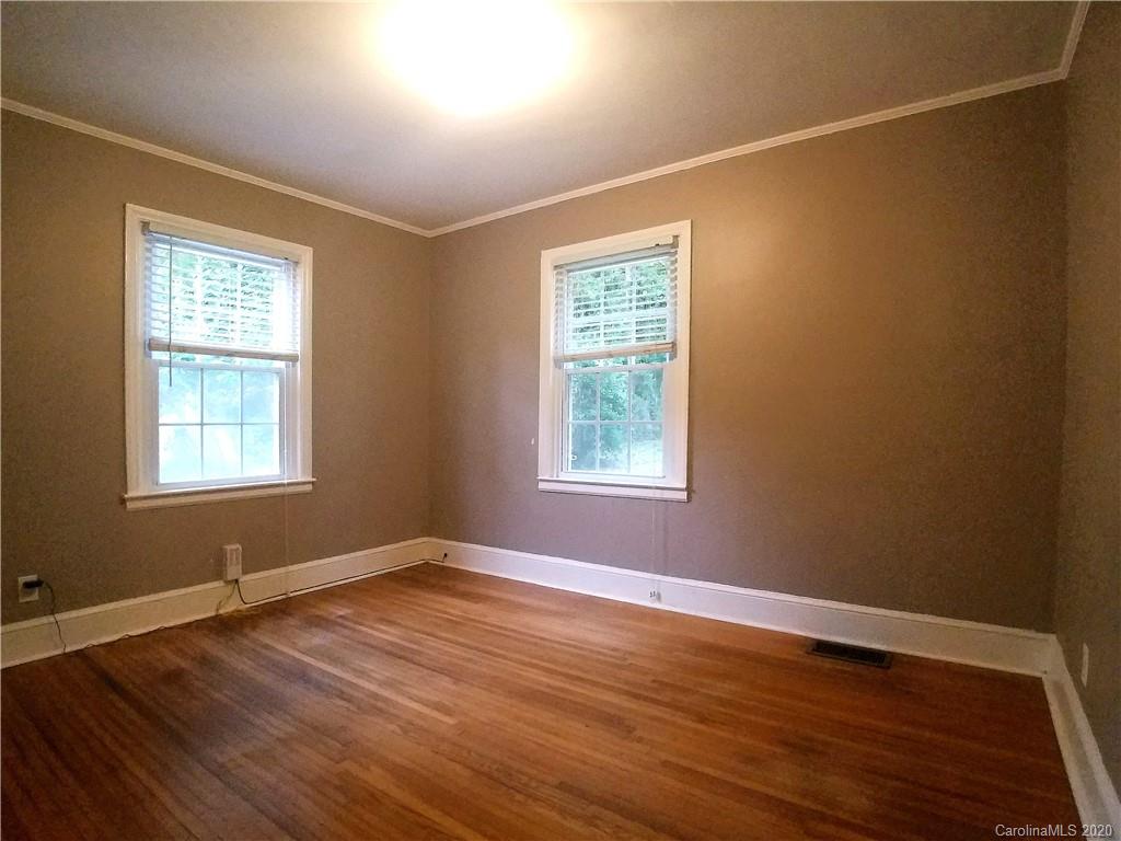 1900 Arnold Drive Charlotte, NC 28205 - Photo 13 of 23 a view of an empty room with wooden floor and a window