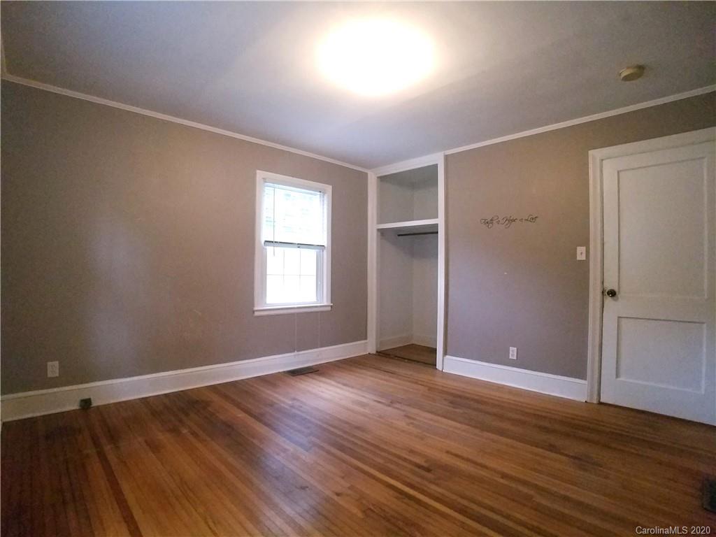 1900 Arnold Drive Charlotte, NC 28205 - Photo 16 of 23 an empty room with wooden floor closet and windows