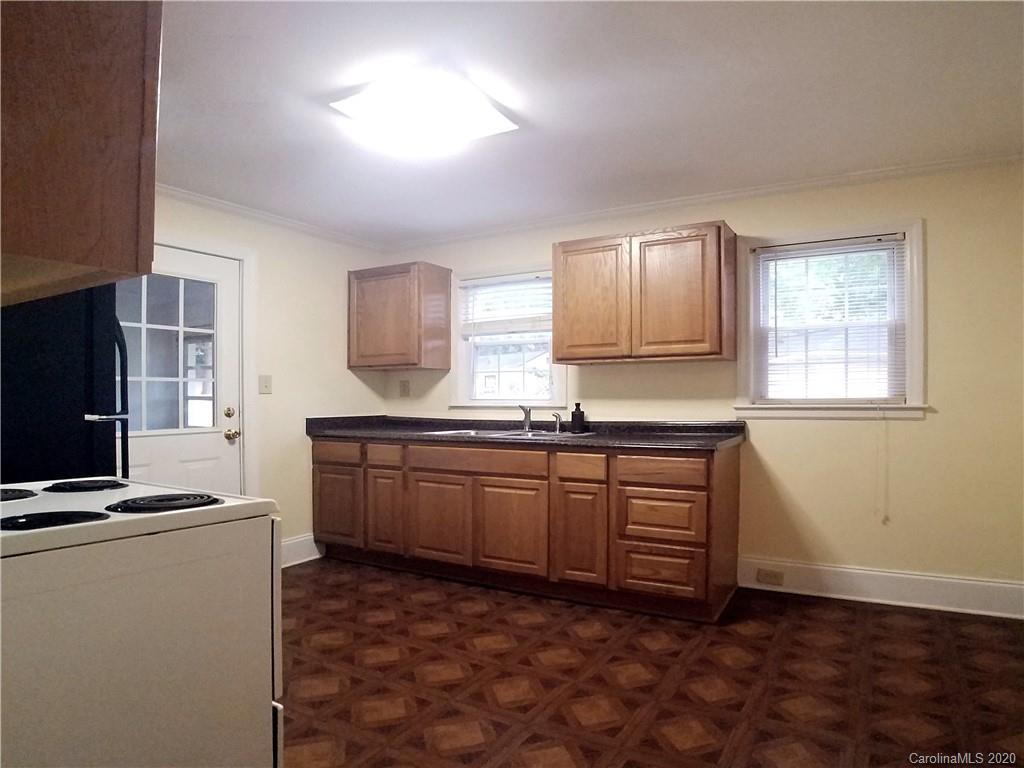 1900 Arnold Drive Charlotte, NC 28205 - Photo 18 of 23 a kitchen with granite countertop a sink cabinets and wooden floor