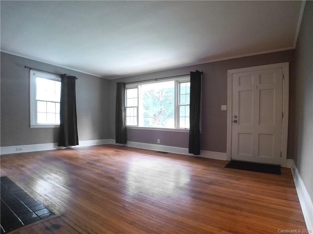 1900 Arnold Drive Charlotte, NC 28205 - Photo 7 of 23 an empty room with wooden floor and windows