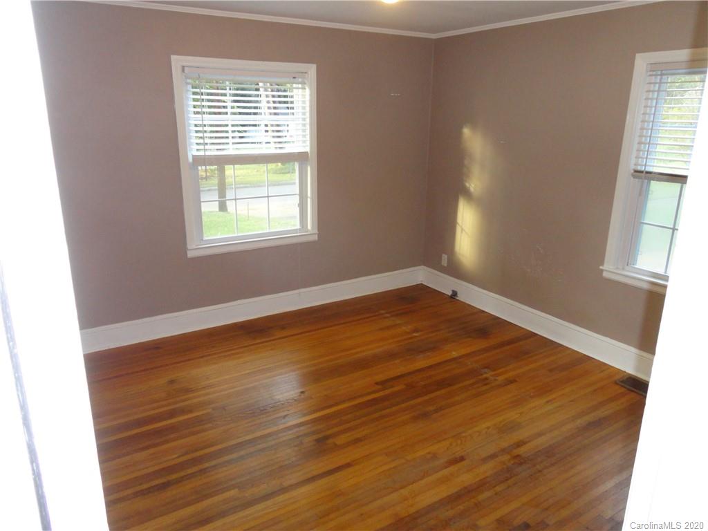 1900 Arnold Drive Charlotte, NC 28205 - Photo 8 of 23 an empty room with wooden floor and windows