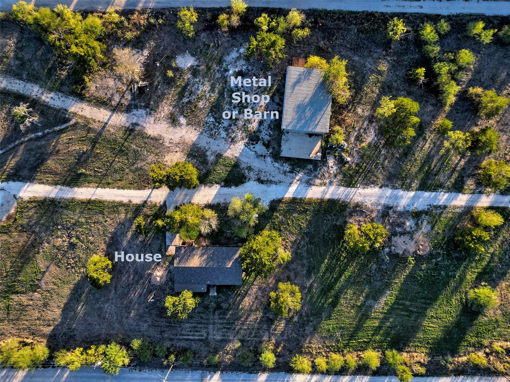 11622 Doyle Overton Road Austin, TX 78719 - Photo 9 of 15 An aerial perspective reveals the layout of the residential structure and detached workshop.
