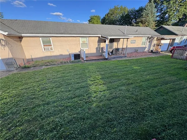 a view of a house with a backyard