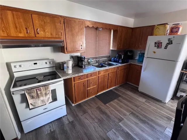 a kitchen with stainless steel appliances granite countertop a stove a sink dishwasher and a refrigerator