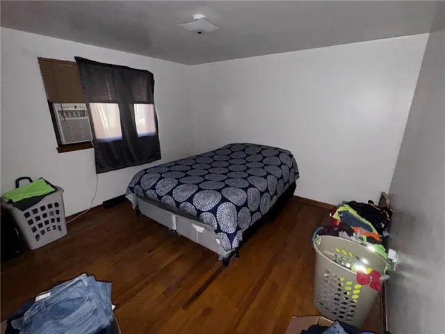 a bedroom with bed and a window