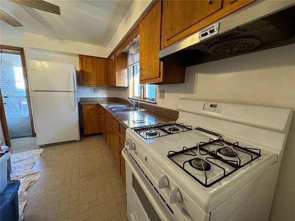 a kitchen with a stove and a refrigerator