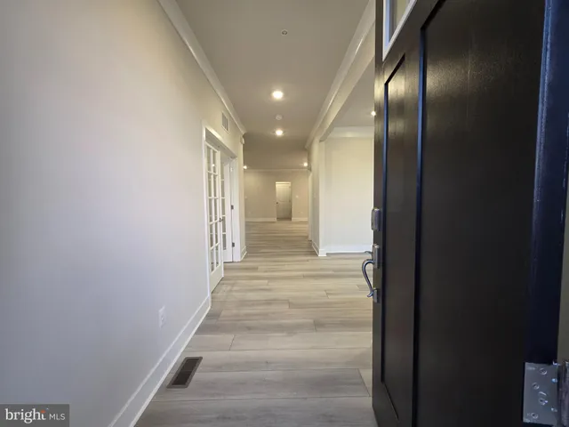 a view of a hallway with wooden floor