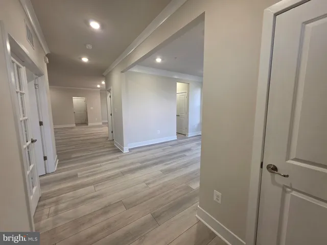 a view of a hallway with wooden floor