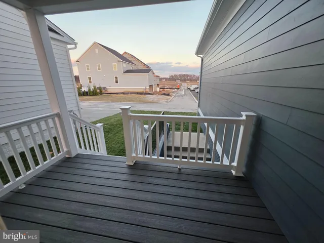 a view of balcony with wooden floor and fence