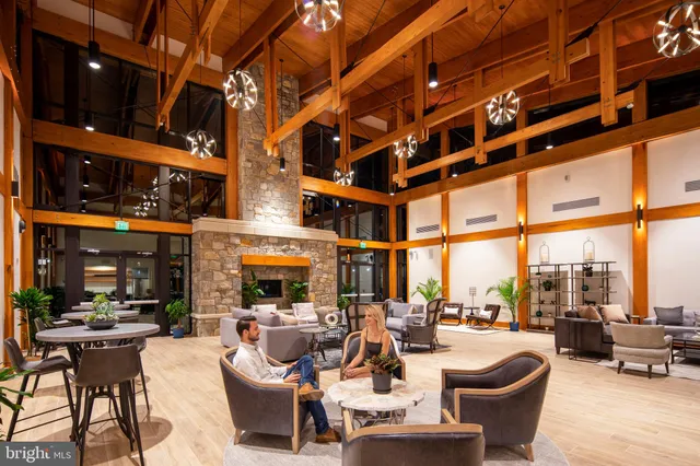 a living room with furniture and floor to ceiling windows