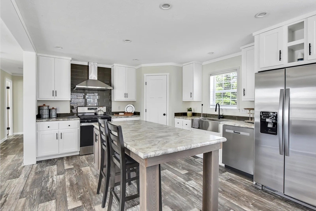 11 Annie's Way West Springfield, MA 01089 - Photo 14 of 18 a kitchen with stainless steel appliances granite countertop a sink a stove a refrigerator cabinets and a window