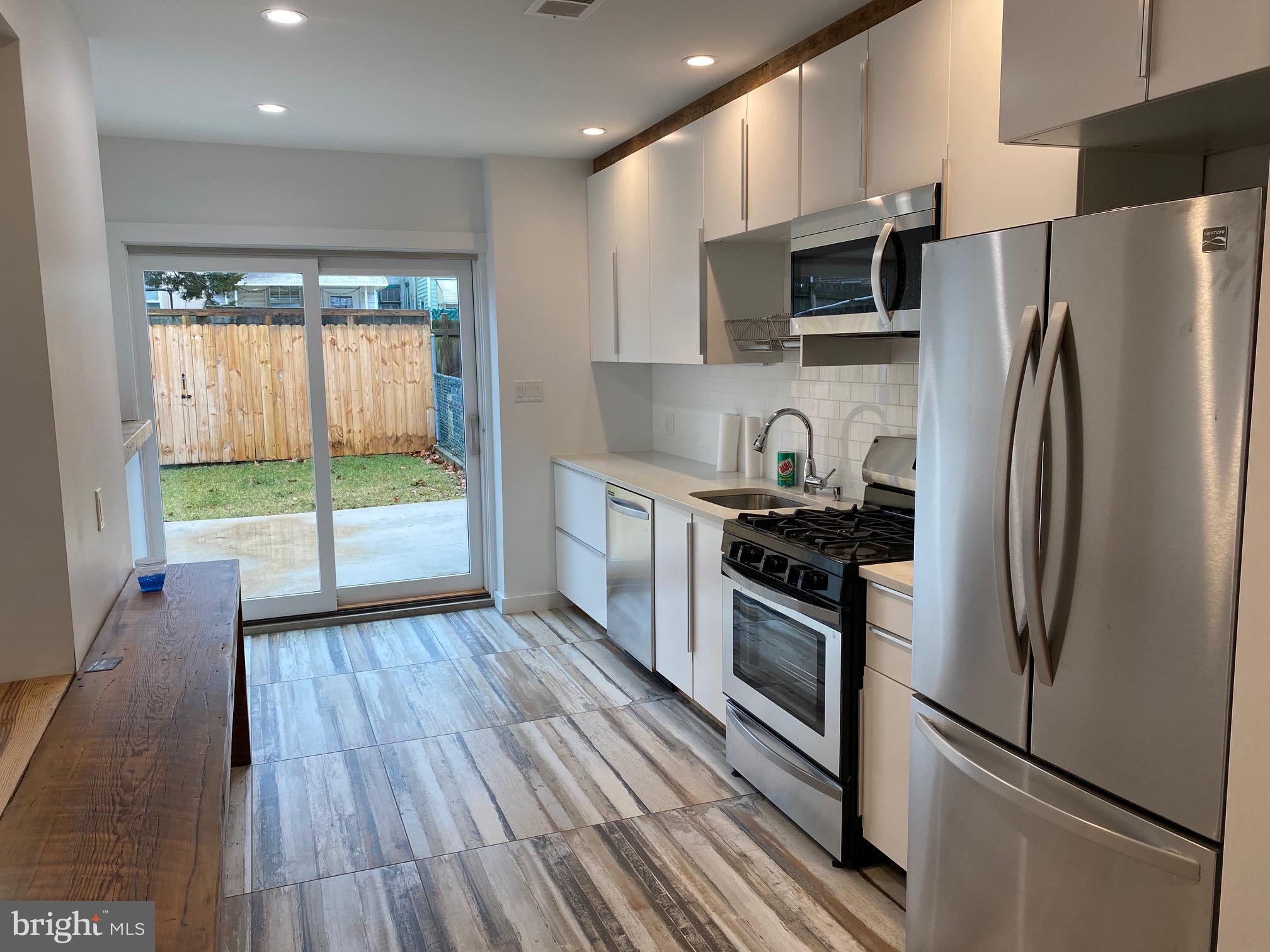 3229 Chatham Street Philadelphia, PA 19134 - Photo 15 of 41 a kitchen with stainless steel appliances a refrigerator sink and microwave