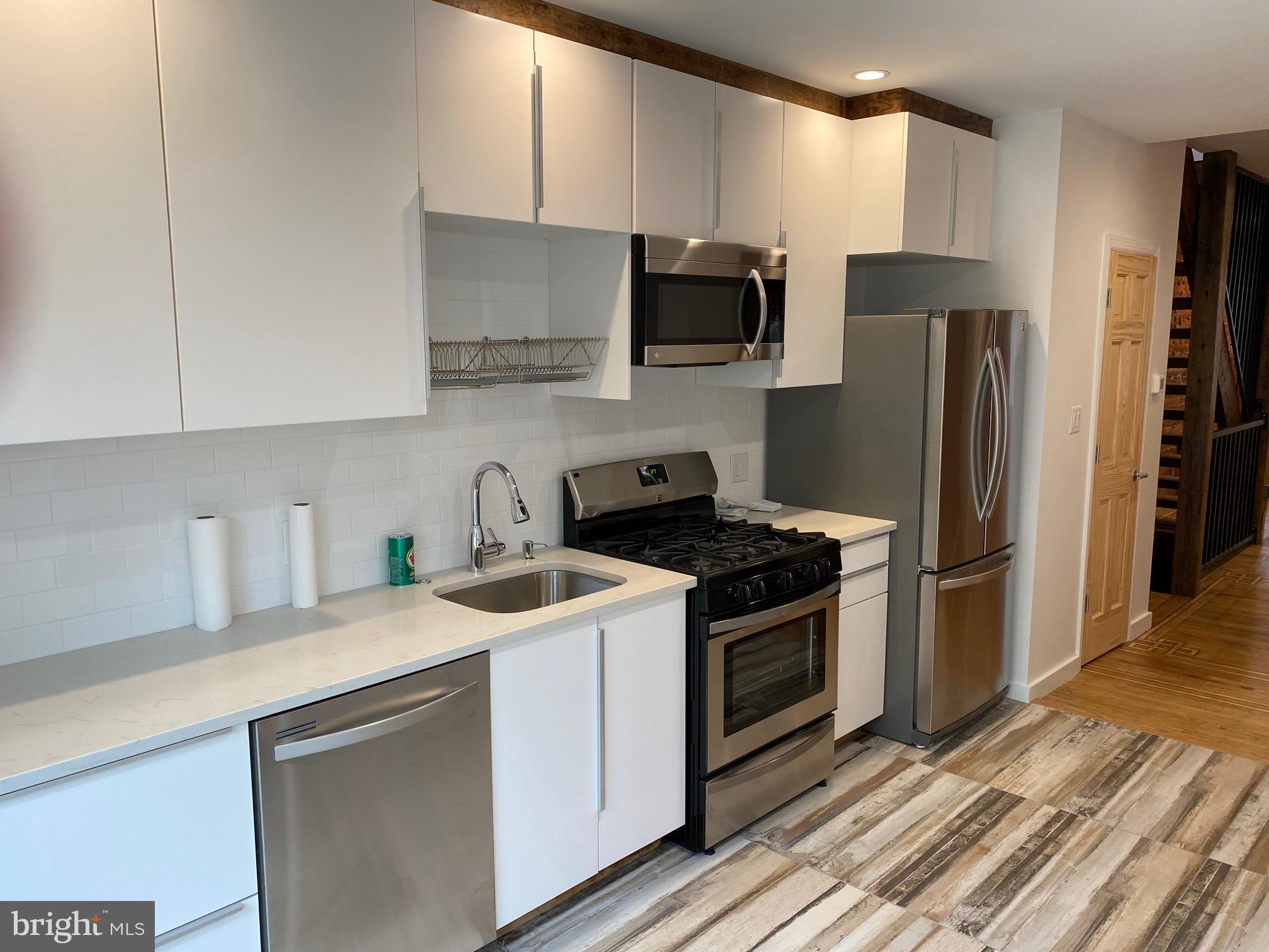 3229 Chatham Street Philadelphia, PA 19134 - Photo 19 of 41 a kitchen with stainless steel appliances granite countertop a sink stove and refrigerator