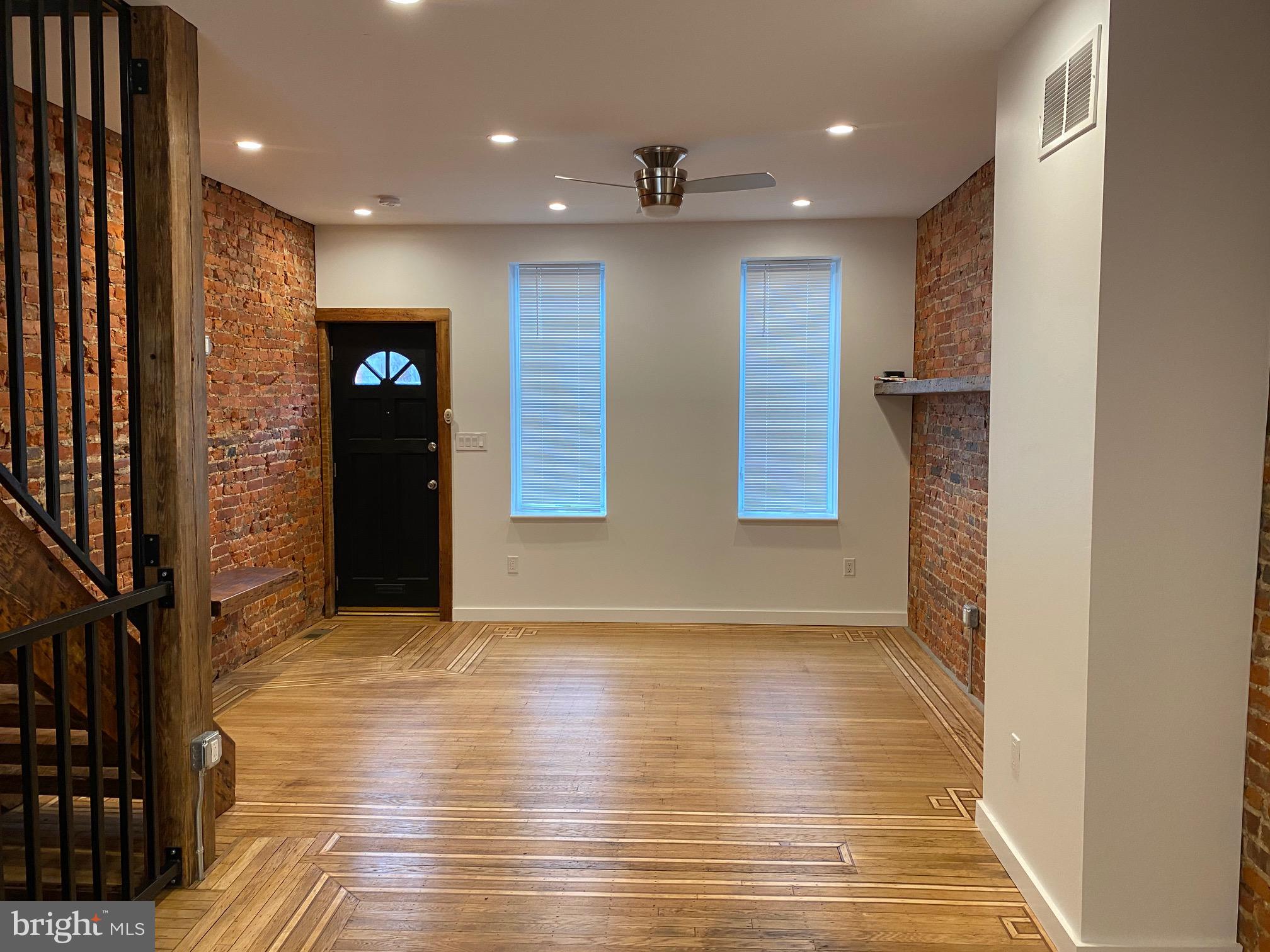 3229 Chatham Street Philadelphia, PA 19134 - Photo 2 of 41 a view of an empty room with wooden floor and a window
