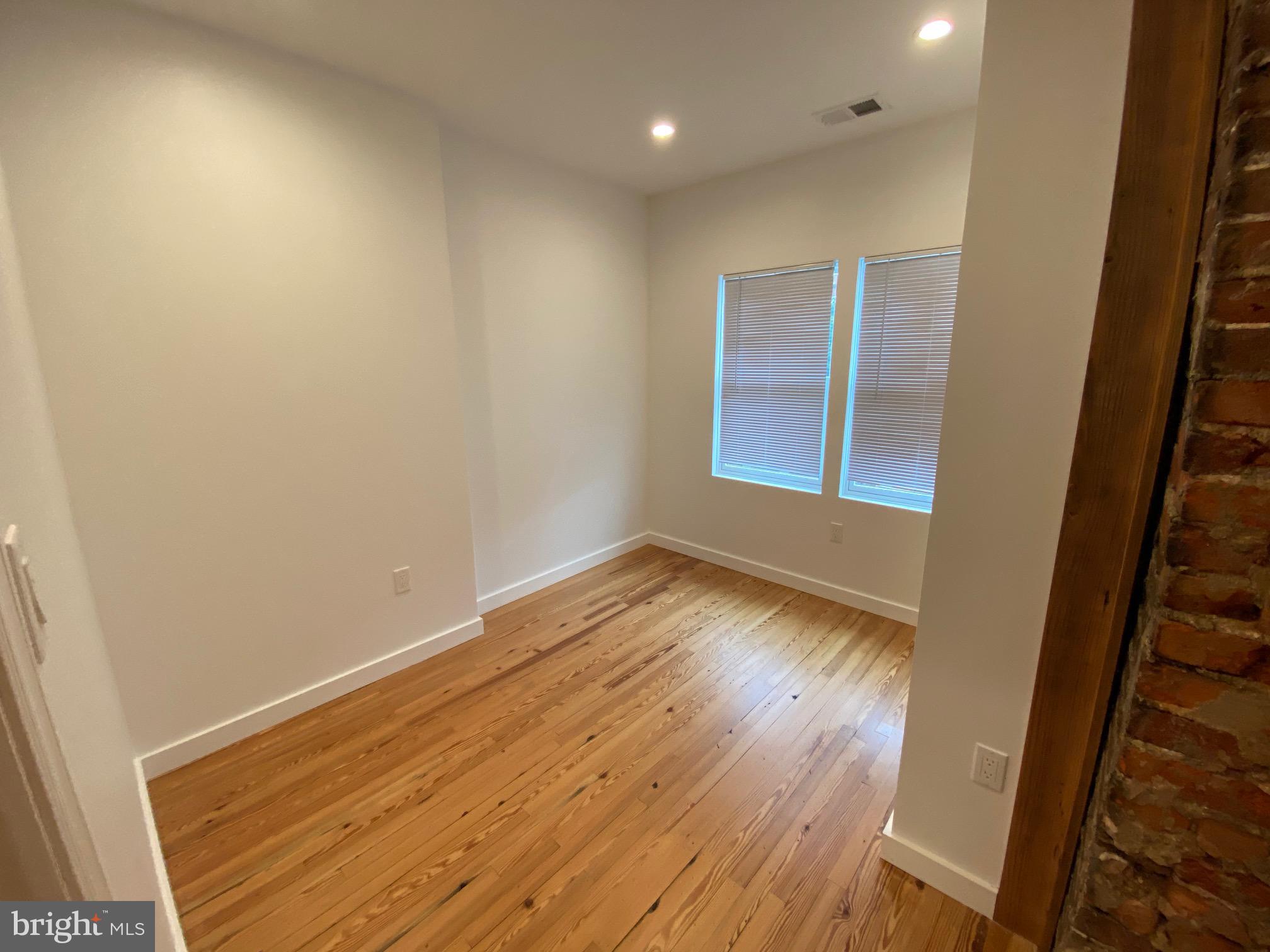3229 Chatham Street Philadelphia, PA 19134 - Photo 28 of 41 an empty room with wooden floor and windows