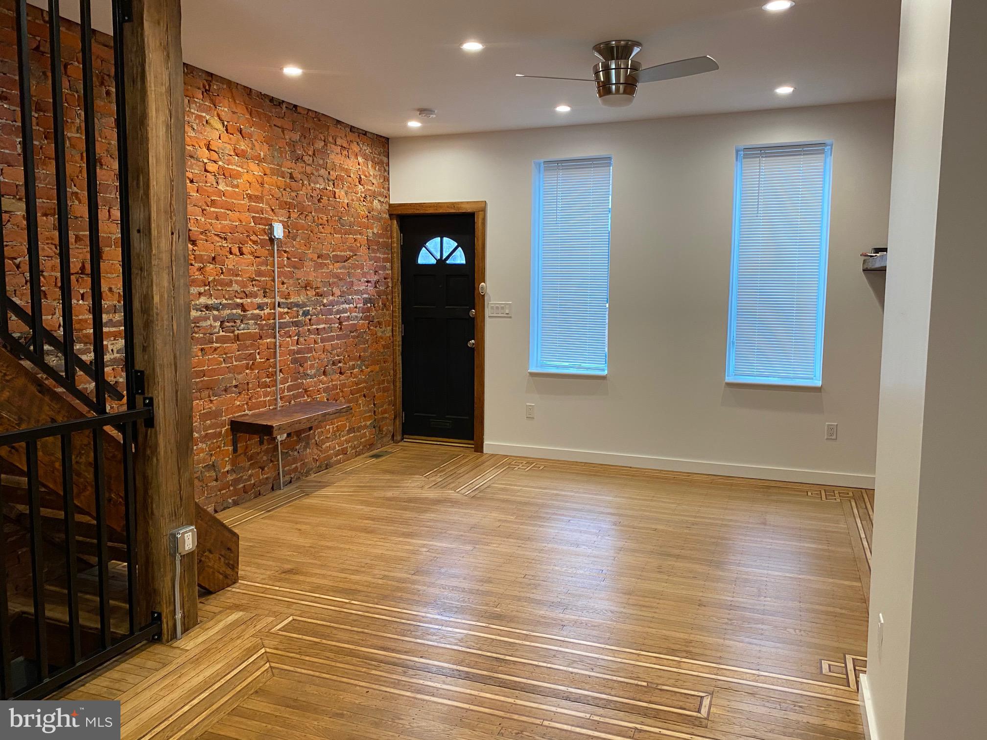 3229 Chatham Street Philadelphia, PA 19134 - Photo 3 of 41 a view of an empty room with wooden floor and a kitchen