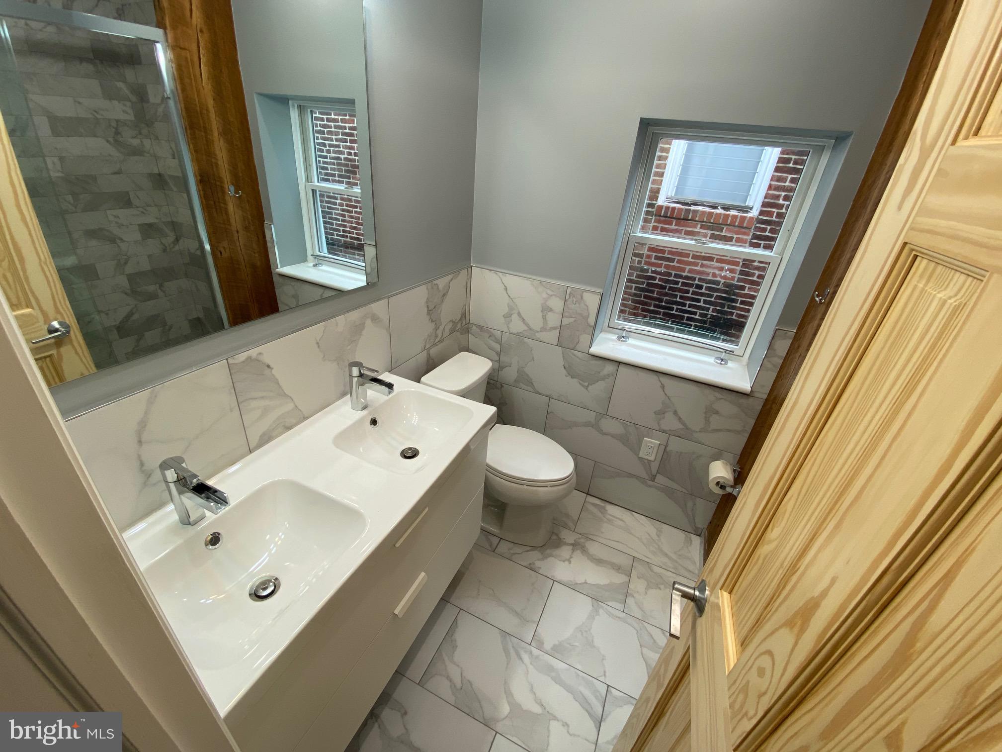 3229 Chatham Street Philadelphia, PA 19134 - Photo 32 of 41 a bathroom with a sink mirror and a toilet