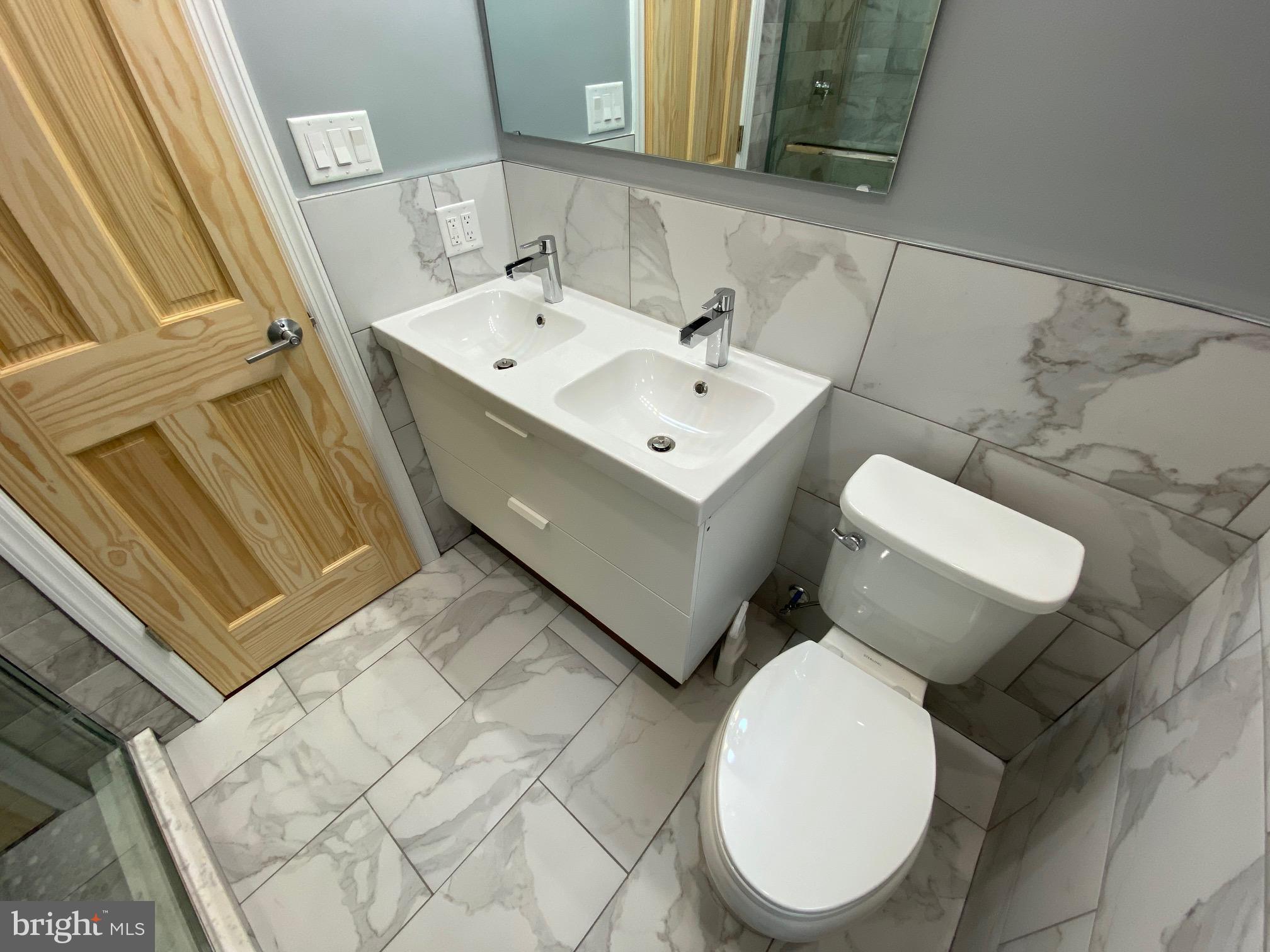 3229 Chatham Street Philadelphia, PA 19134 - Photo 33 of 41 a bathroom with a toilet sink and mirror