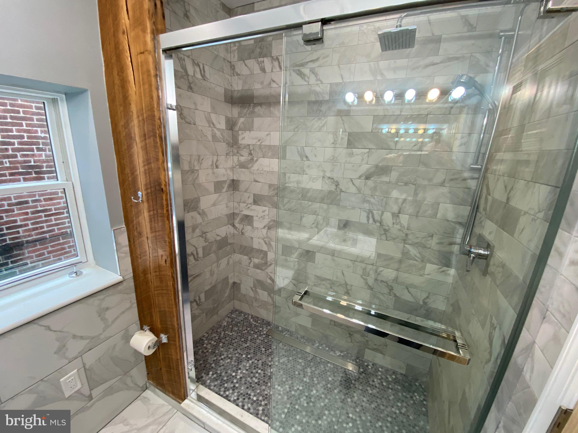 3229 Chatham Street Philadelphia, PA 19134 - Photo 35 of 41 a bathroom with a glass shower door