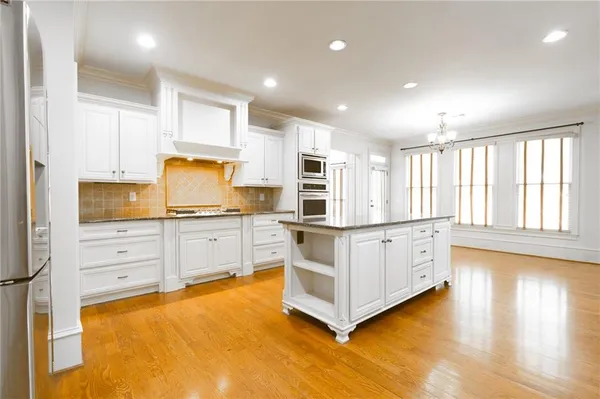 a view of a room with wooden floor chandelier and entryway