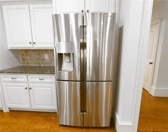 a spacious bathroom with a granite countertop sink a mirror and a