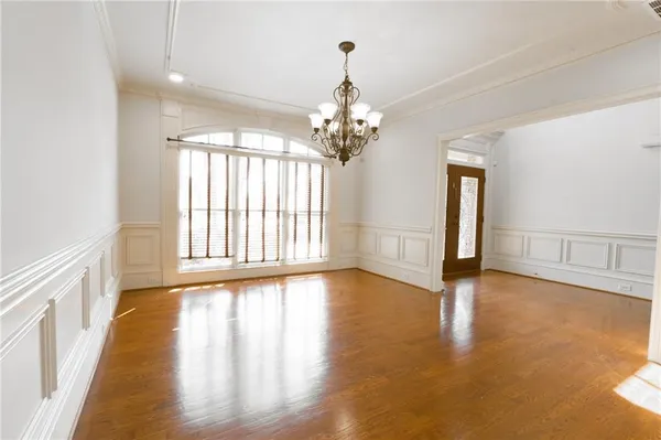 a spacious bathroom with a granite countertop sink a mirror and a shower