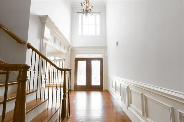 a white toilet sitting next to a white cabinet