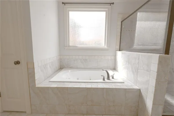 a view of an empty room with a window and fireplace