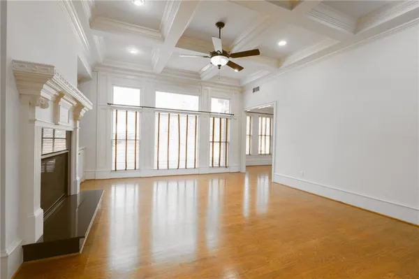 a white toilet sitting next to a white wall