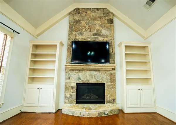 a living room with a fireplace and a flat screen tv