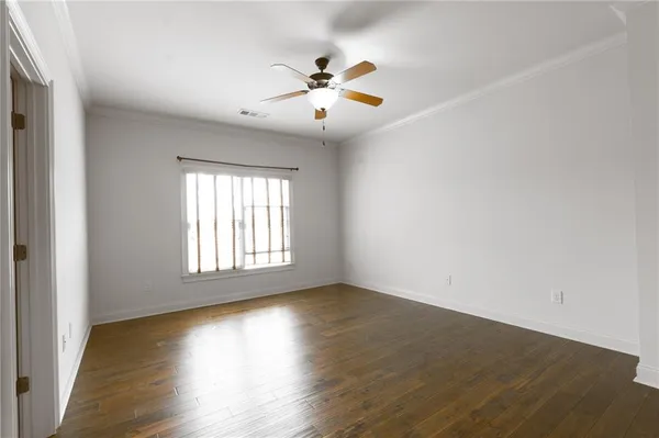 a view of a hallway with wooden floor and stairs