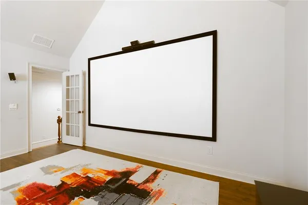 a front view of a house with a garden and yard