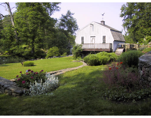 27 Mill Run Road Boxford, MA 01921 - Photo 6 of 17 a front view of a house with a yard and garage