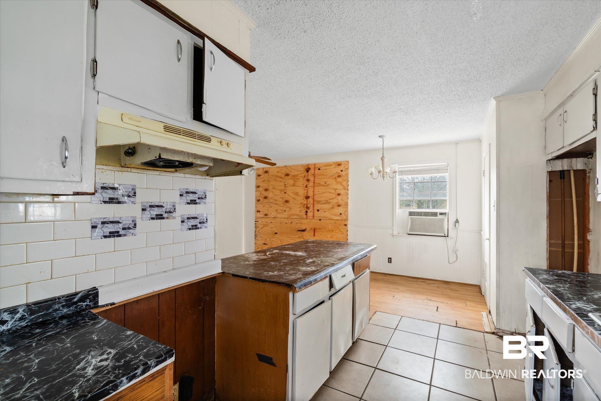 313 West 4th Avenue Foley, AL 36535 - Photo 6 of 20 Kitchen featuring light tile patterned flooring, tasteful backsplash, a textured ceiling, cooling unit, and white cabinets