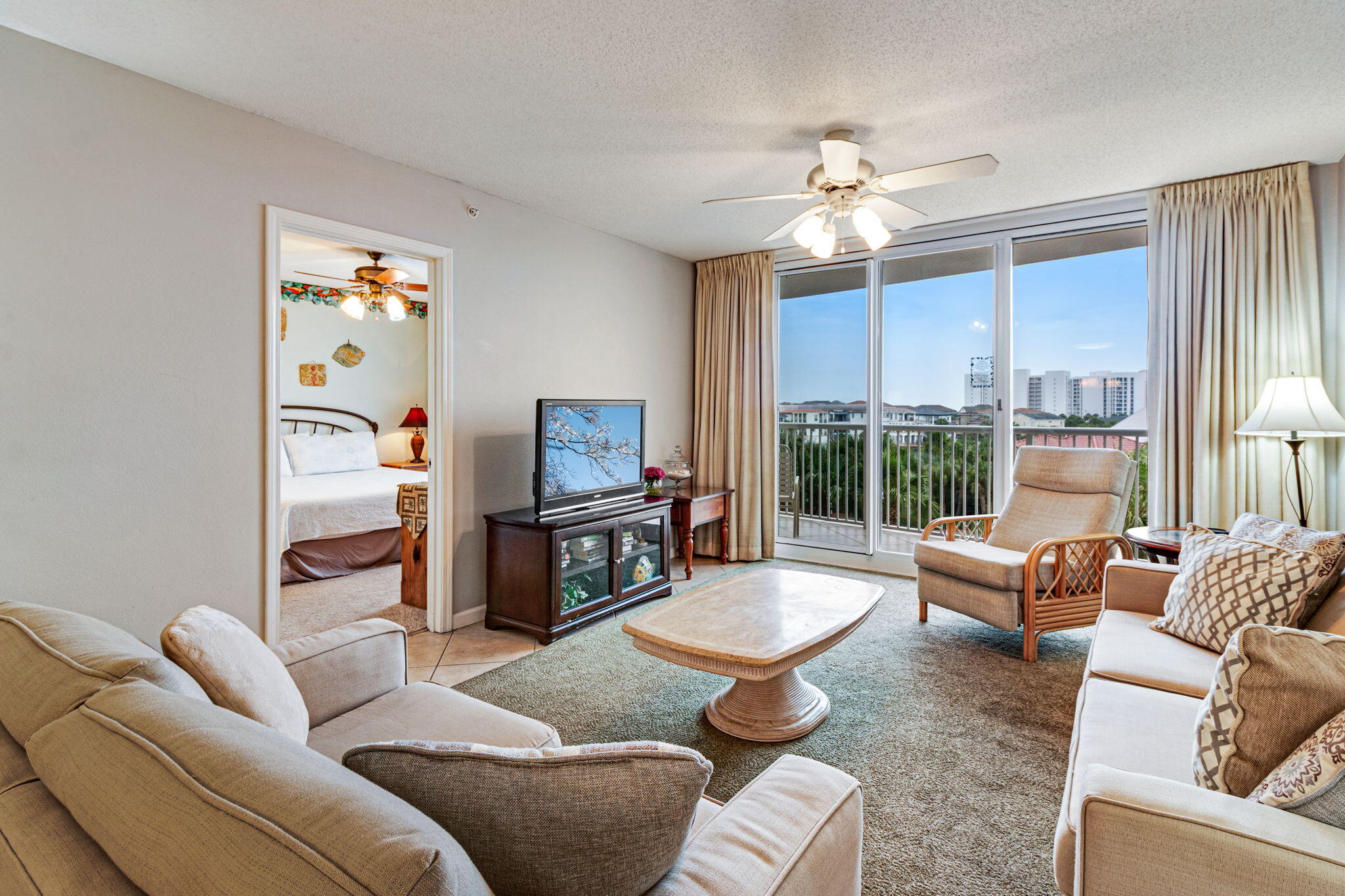 970 Highway 98, Unit 303 Destin, FL 32541 - Photo 5 of 42 a living room with furniture a fireplace and a flat screen tv