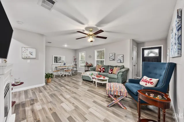 a living room with furniture and wooden floor