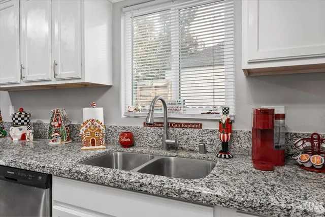 a kitchen sink with granite countertop a sink and cabinets