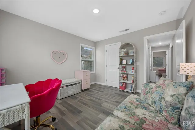 a bathroom with a toilet sink vanity and mirror