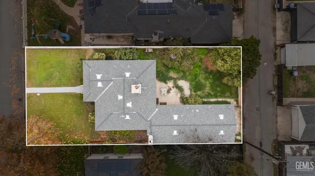 an aerial view of a house with a yard