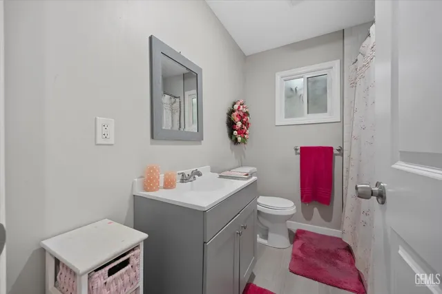 a spacious bedroom with a bed and wooden floor